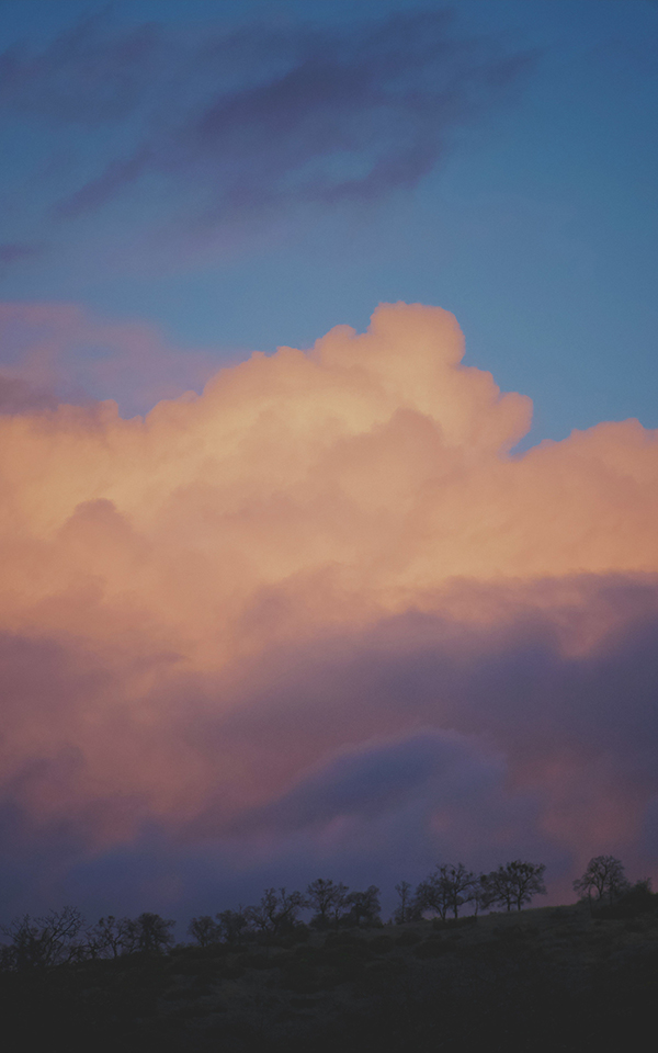 Sun rising above clouds